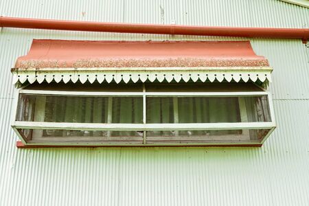 Enclosed window on an old colonial house, design typical of it's bygone eraの写真素材