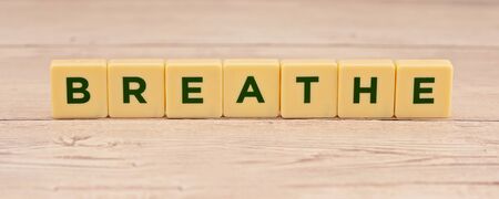Breathe spelt out in block capital letters, encouragement to relax and enjoyの写真素材