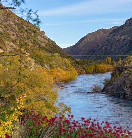 Tourists on Kawarau River jet boat adrenalin thrill riding through the canyon in New Zealand