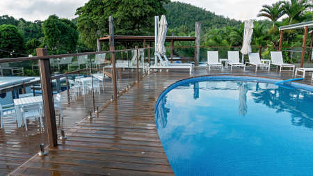 Airlie Beach, Queensland, Australia - March 2020: Pool and deck area for casual dining and swimming at Freedom Shores Resort after rainのeditorial素材