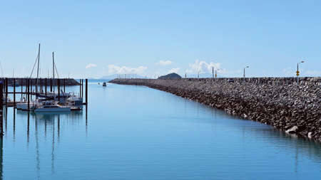 Mackay, Queensland, Australia - June 2020: Boats berthed at and leaving the marina, which is protected by a rock wallのeditorial素材