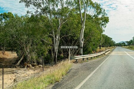 Good Bye Creek sign at the creek crossing on a rural highwayの写真素材