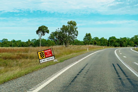 Prepare to stop sign on a country highway warning not to overtake other vehicles