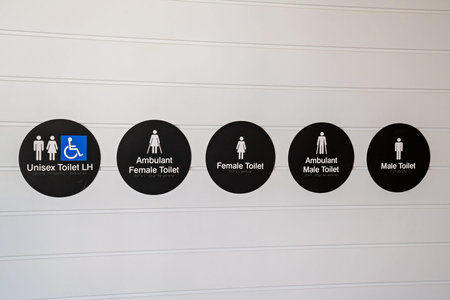 Signs and icons including braille for toilet facilities at a luxury hotel