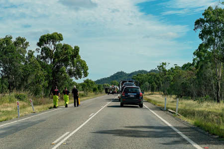 Townsville, Queensland, Australia - June 2020: Emergency service workers walk along the road towards an accidental truck rollover which held up traffic on the highwayのeditorial素材