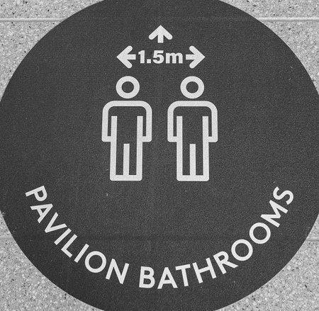 Townsville, Queensland, Australia - June 2020: Signage stating minimum distance in bathrooms during...