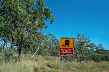 Road train route sign advising smaller vehicles to use the road should when overtaking or approaching a long haulage vehicle in Australiaの写真素材