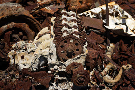 The rusted remains of a burnt out car left abandoned on tidal salt flatsの写真素材