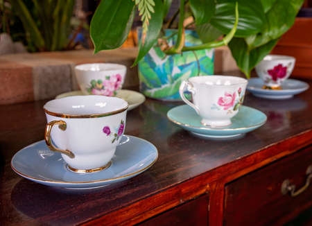A row of decorative tea cups on display at a coffee shop.の写真素材