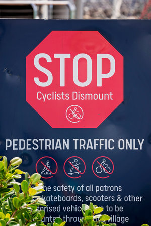 Pedestrian traffic only signage indicating cyclists must stop and dismount