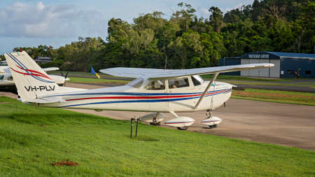 Airlie Beach, Queensland, Australia - February 2021: A light aircraft parked beside the airport runwayのeditorial素材