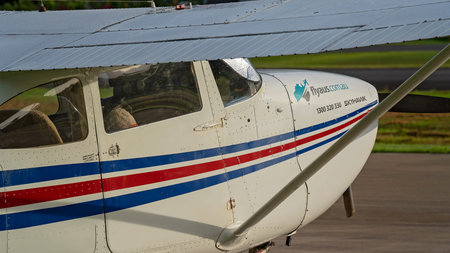 Airlie Beach, Queensland, Australia - February 2021: A light aircraft parked beside the airport...