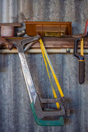 Assorted hacksaws hanging on a shed wallの写真素材