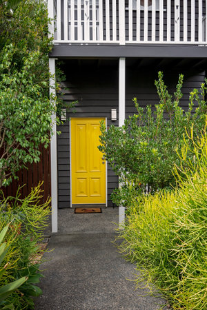 Brisbane, Queensland, Australia - March 2021: Entrance door in bright yellow in a renovated old Queensland homeのeditorial素材