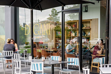 Brisbane, Queensland, Australia - March 2021: People dining inside and outside of a city coffee shop cafeの写真素材