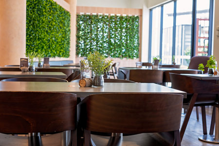 Brisbane, Queensland, Australia - March 2021: Inside a light filled restaurant with tables decorated...