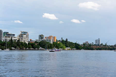 Brisbane, Queensland, Australia - March 2021: Fast ferry on the river against the city skylineのeditorial素材