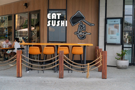 Brisbane, Queensland, Australia - March 2021: Sushi restaurant in the city with a couple dining at a street tableのeditorial素材