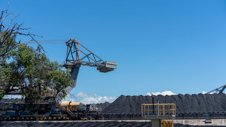 Mackay, Queensland, Australia - March 2021: Giant machinery amongst coal stockpiles at export terminalのeditorial素材