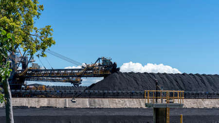 Mackay, Queensland, Australia - March 2021: Giant machinery amongst coal stockpiles at export terminalのeditorial素材