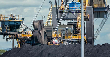 Mackay, Queensland, Australia - March 2021: Giant machinery amongst coal stockpiles at export terminalのeditorial素材