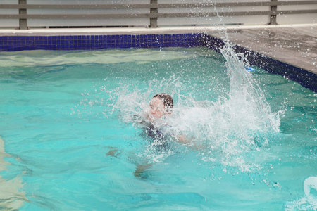 Jumping in the swimming pool and splashing fun