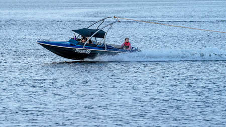 Mackay, Queensland, Australia - April 2021: People in a power boat on a dam towing tubersのeditorial素材