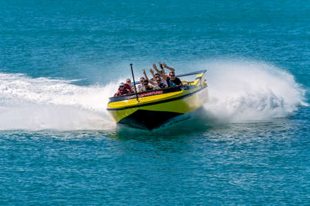 Airlie Beach, Queensland, Australia - April 2021: Passengers having fun in a jet boat adrenaline ride on the ocean at Whitsundaysのeditorial素材