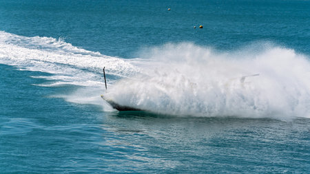 Thick ocean spray hides a spinning jet boat full of tourists enjoying their adrenaline ride
