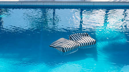 Floating Cushions available for guest use in the pool at a luxury resort hotelの写真素材