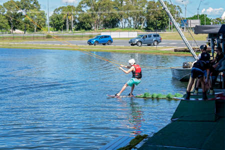 Mackay, Queensland, Australia - April 2021: Man learning to wakeboard at a cable ski parkのeditorial素材