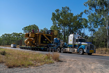 Clermont, Queensland, Australia - May 2021: Road train transporting over sized machinery out to the...
