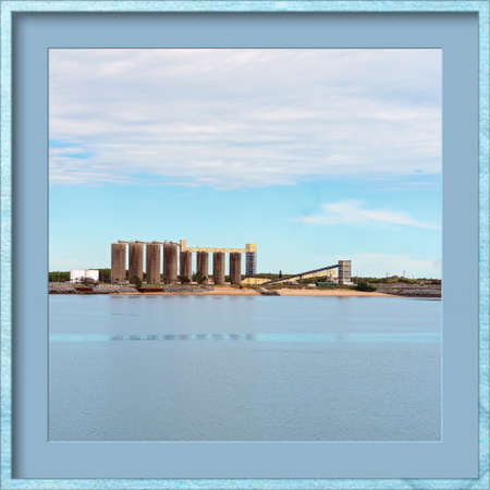 Industrial wharf of an Australian city's harbor, matted and framed in blueの写真素材