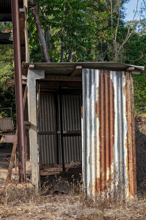 An old rusting garden shed beside a higher structure in the country, both disused and neglected and about to fall down from disrepairの写真素材