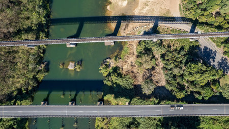 Aerial pattern landscape looking down onto road and rail bridges with shadows
