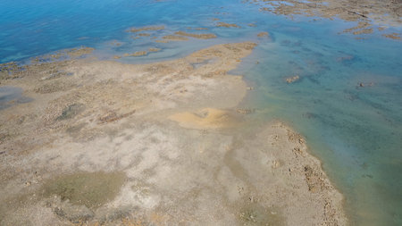 Aerial landscape of ocean at low tide showing sandbanks and seawater in abstract patterns. Cape...