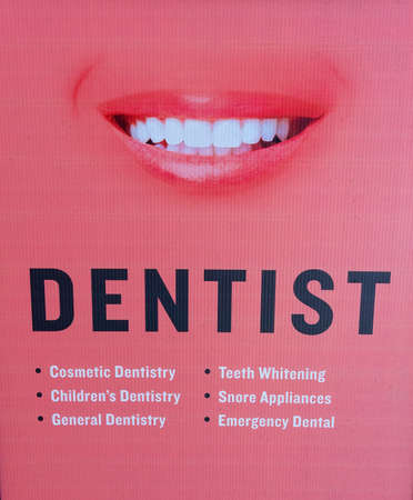 Mackay, Queensland, Australia - September 2021: A smile with white teeth dentist sign in the cityのeditorial素材