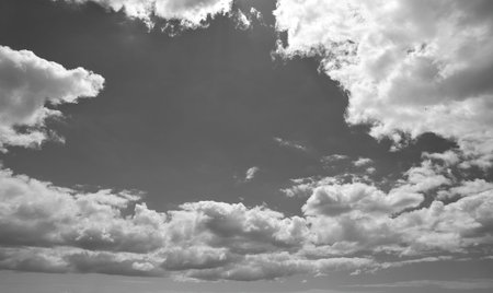 Monotone of fluffy clouds in the sky, room for copy text