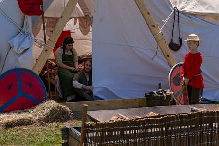 Eungella, Queensland, Australia - October 2021: Young boy and two adults dressed in replica viking costumes near a tent in a re-enactment village at a country fairのeditorial素材