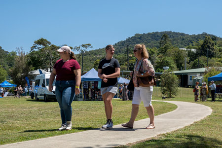 Eungella, Queensland, Australia - October 2021: Three women walking along a footpath as they explore a viking re-enactment fairのeditorial素材