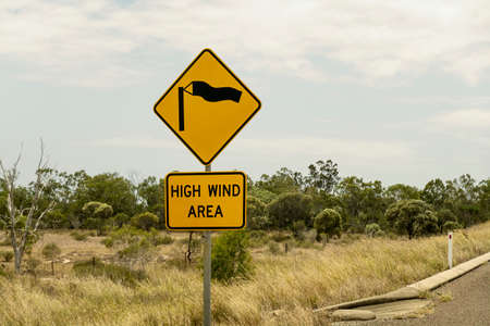 Roadside signage warning of a high wind area aheadの写真素材