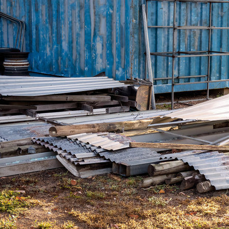 Sheets of corrugated iron lying in scattered pile in a suburban backyard