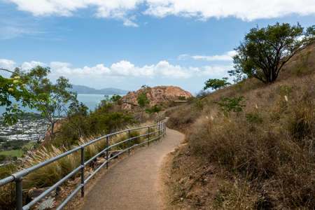 A tourist walking track along the side of a mountain of pink granite with city viewsのeditorial素材