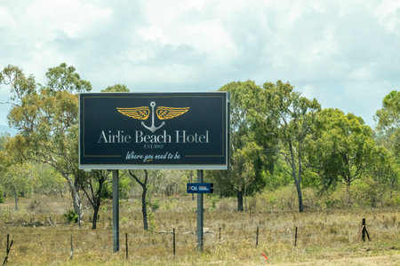 Bruce Highway Townsville to Mackay, Queensland, Australia - November 2021: Outdoor roadside advertising billboard for Airlie Beach Hotelのeditorial素材