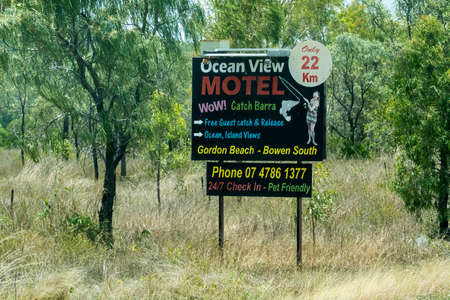 Bruce Highway Townsville to Mackay, Queensland, Australia - November 2021: Roadside sign advertising motel with ocean viewのeditorial素材