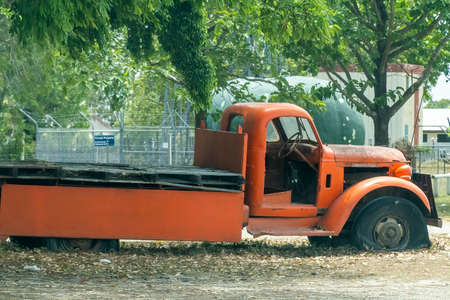 Bruce Highway Townsville to Mackay, Queensland, Australia - November 2021: Vintage truck parked under a tree with flat tyresのeditorial素材