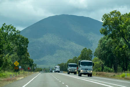 Bruce Highway Townsville to Mackay, Queensland, Australia - November 2021: Trucks carting freight on highwayのeditorial素材