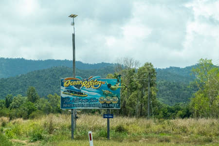 Bruce Highway Townsville to Mackay, Queensland, Australia - November 2021: Ocean Rafting business outdoor advertising billboardのeditorial素材