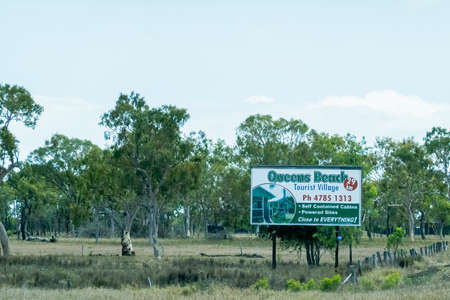 Bruce Highway Townsville to Mackay, Queensland, Australia - November 2021: Queens Beach Tourist Village Advertising Billboardのeditorial素材