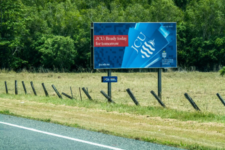Bruce Highway, Townsville to Mackay, Queensland, Australia - November 2021: James Cook University outdoor advertising signのeditorial素材